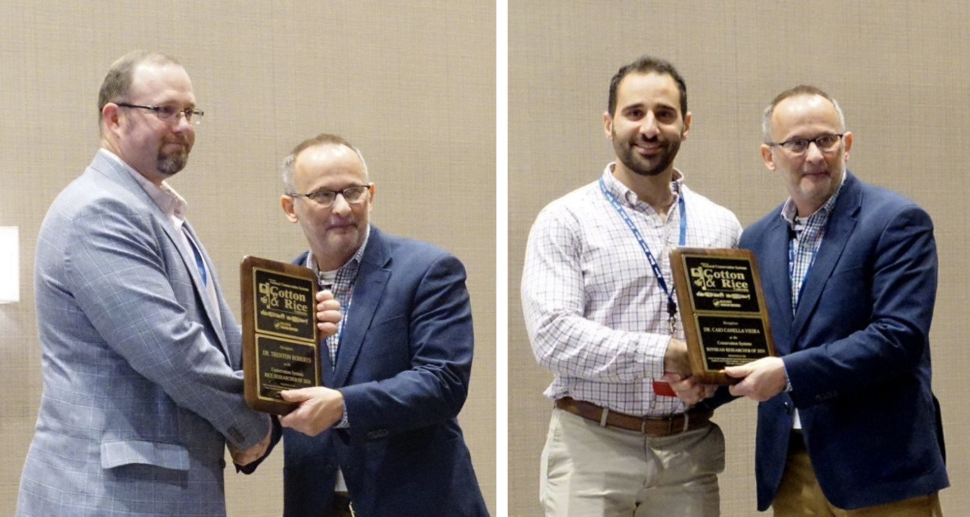 Trent Roberts, left, and Caio Vieira, accepting awards at the National Conservation Systems Conference.