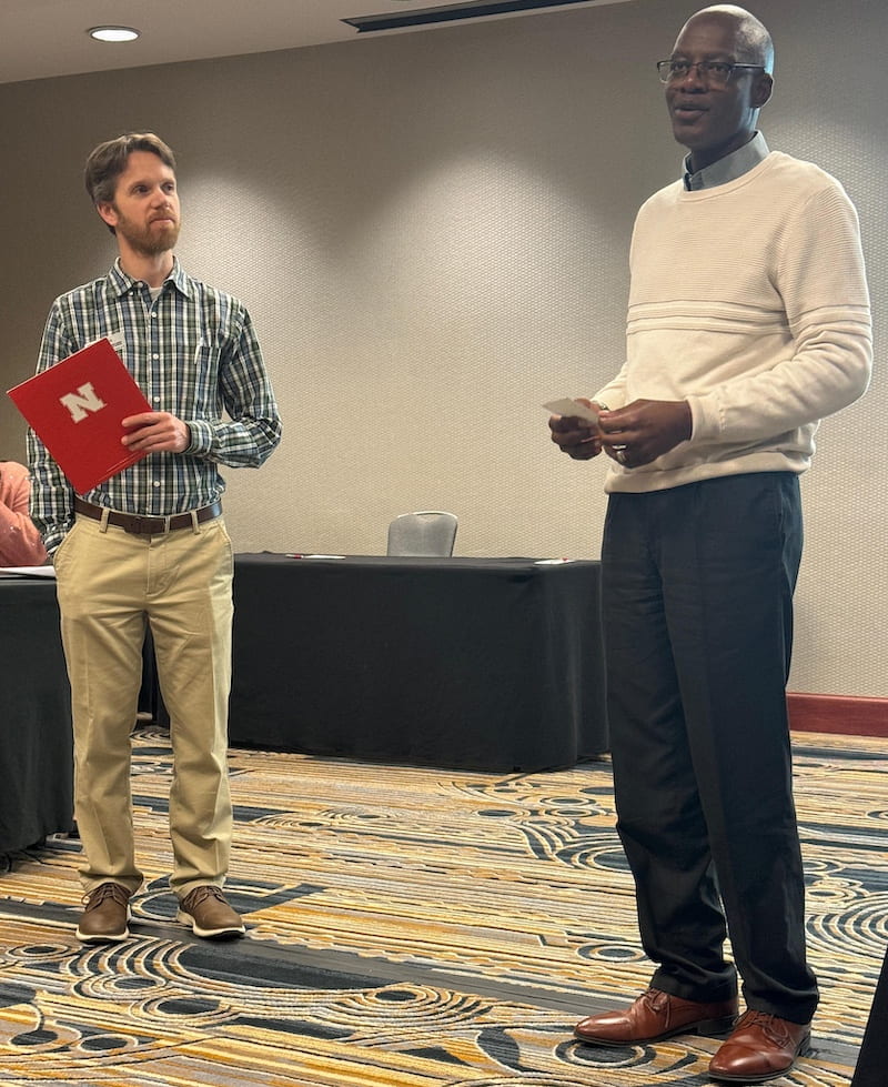 AWARD OF EXCELLENCE — Griffiths Atungulu, right, accepts the 2024 Andersons Cereal and Oilseeds Award of Excellence from Devin Rose with NC-213: The U.S. Quality Grains Research Consortium. (Courtesy photo)